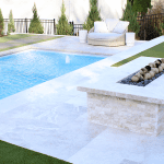 luxury pool with seating and fire feature around pool